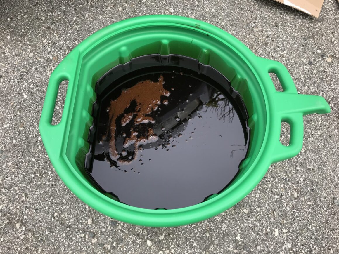 old motor oil drained into capri oil drain pan