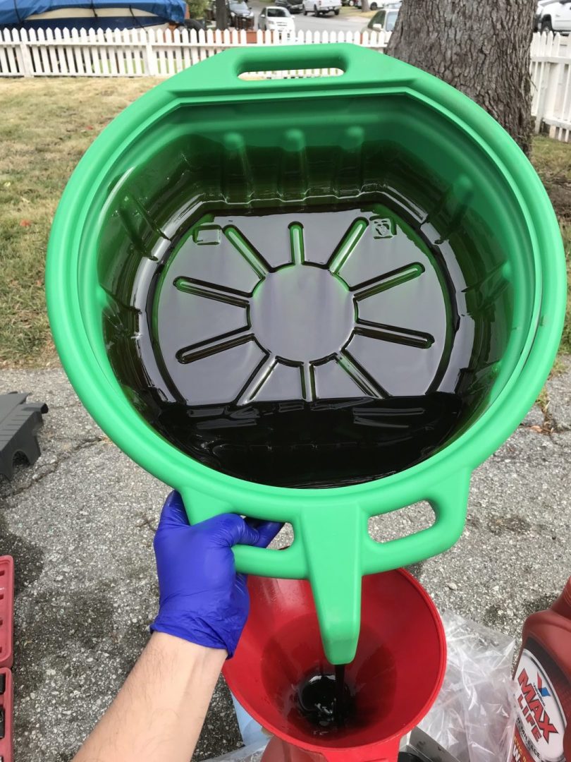 dumping out old motor oil out of capri drain pan